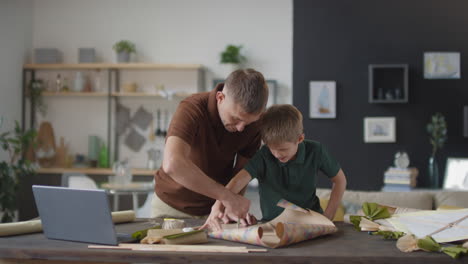 father and son making crafts together