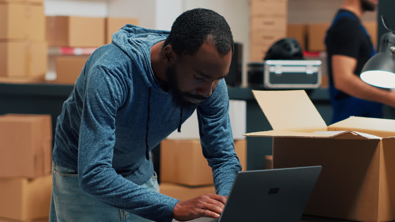 People working in a warehouse packing boxes