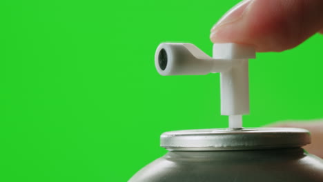 hand pressing air freshener spray button