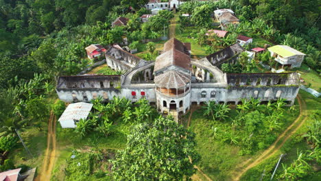 Drone-flying-away-from-a-Old-Hospital-in-Roça-Agua-Izé,-Sao-Tome-and-Principe