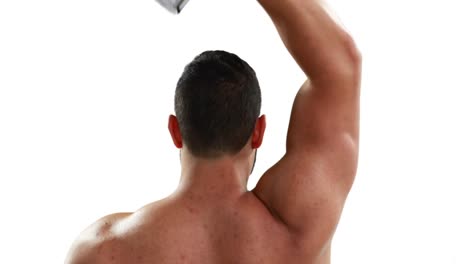 Muscular-bodybuilder-lifting-dumbbell-above-his-head