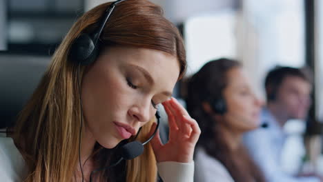 nervous telemarketing assistant talking headset closeup. annoyed woman talking