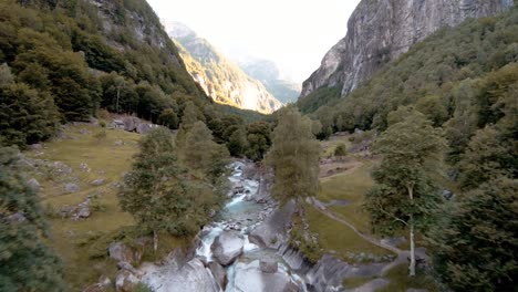 fpv aerial drone shot of waterfall near town of foroglio, ticino, switzerland