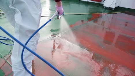 slow motion 4k closeup red fluid preparation high-pressure ship deck floors from a pressure washer