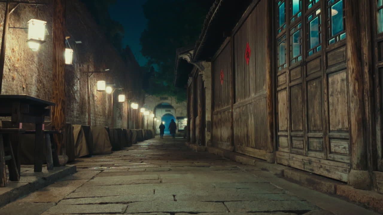 Quiet narrow alley at night in Wuzhen, China with lit lanterns and historic buildings