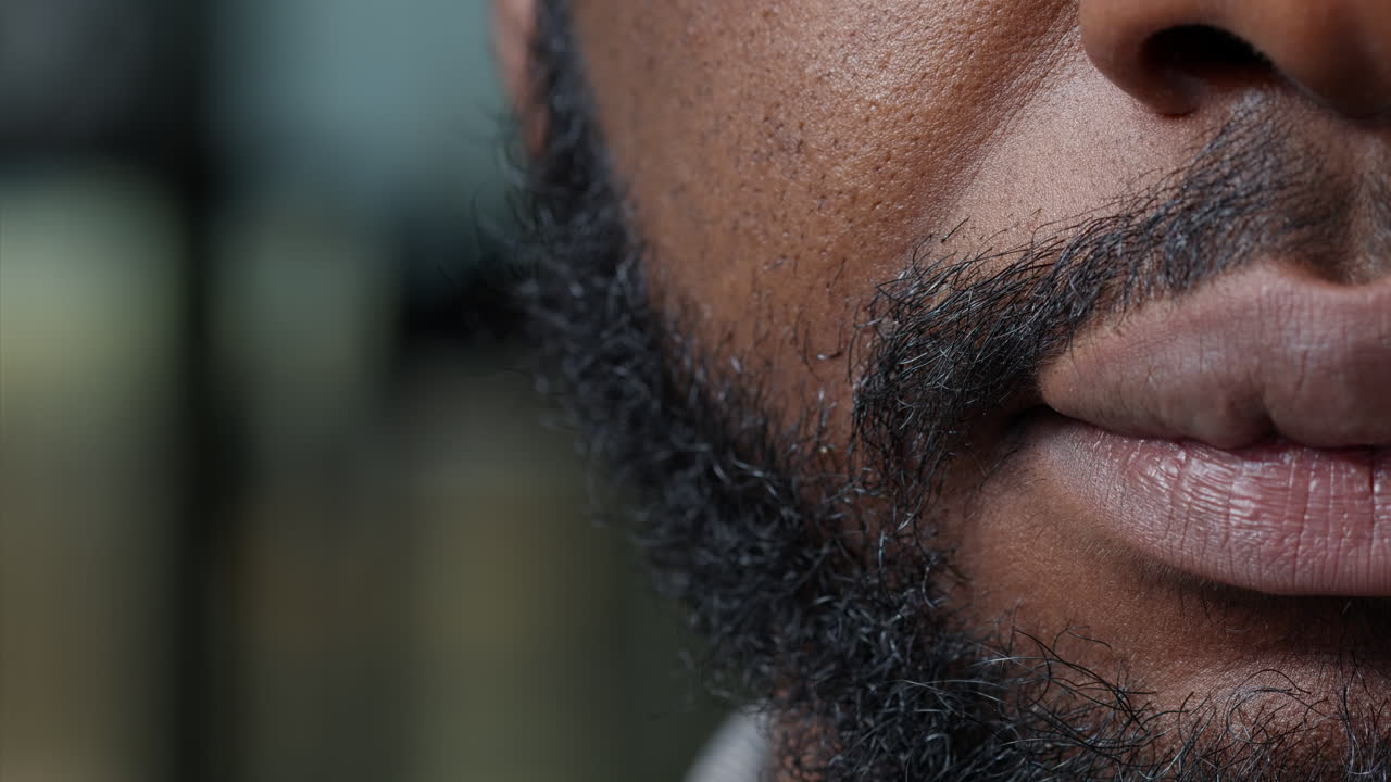 Macro shot of male model moving his lips and showing half of face