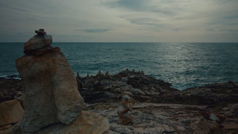 coastal landscape with stacks of stones by the sea