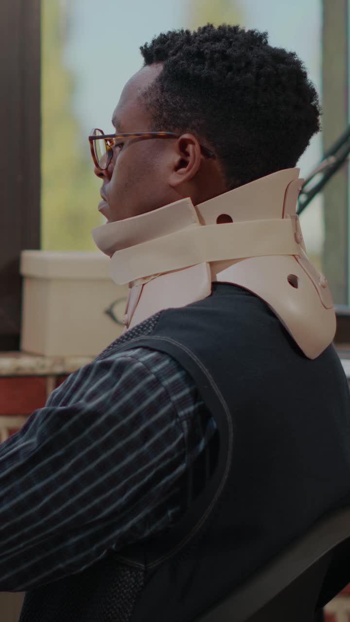 Man wearing a neck brace in the office