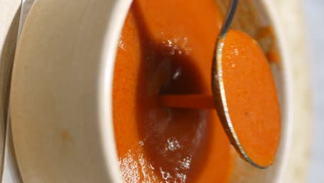close-up of a bowl of hot, orange soup