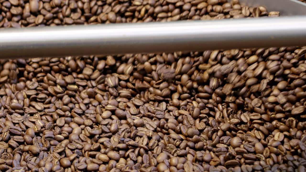 Watch coffee beans transform during roasting enhancing aroma and flavor for a perfect brew.