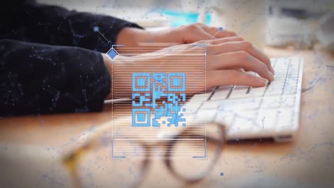 Animation-of-qr-code-and-shapes-over-caucasian-woman-using-computer