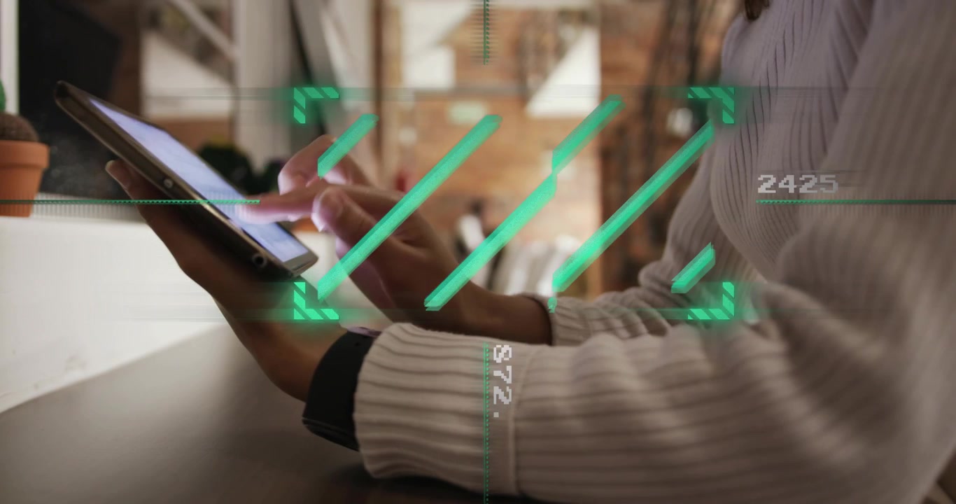 Woman sitting at counter tapping and swiping tablet activating HUD and updating technology metrics