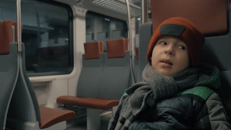 boy in moving commuter train at night