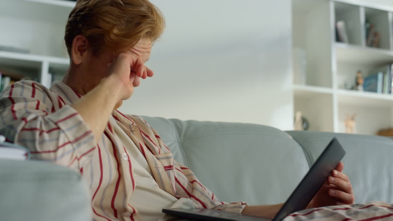 Sleepy millennial working computer closeup. Tired businessman analyze reports