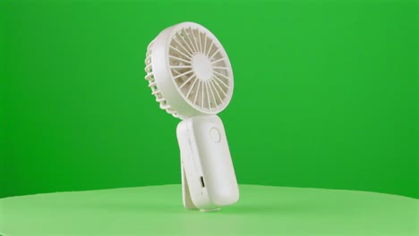 handy fan electric hand mobile ventilator handyfan portable heat hot in a turntable with green screen for background removal 3d