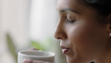 portrait-beautiful-young-indian-woman-drinking-coffee-at-home-enjoying-relaxed-morning-looking-out-window-thinking-planning-ahead-close-up