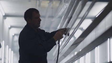 men in the production of steel structures prepare parts for painting in the paint shop