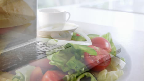 laptop and salad in blur background