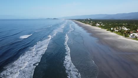 slow forward movement with drone filming a thin layer of waves breaking at dawn, soft light