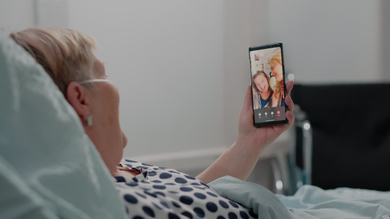 Aged patient talking on video call with niece and daughter