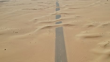 desert road through sand dunes