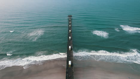 epic shot of pier in atlantic ocean, bogue inlet pier emerald isle nc