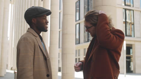 two diverse businessmen speaking on street in downtown