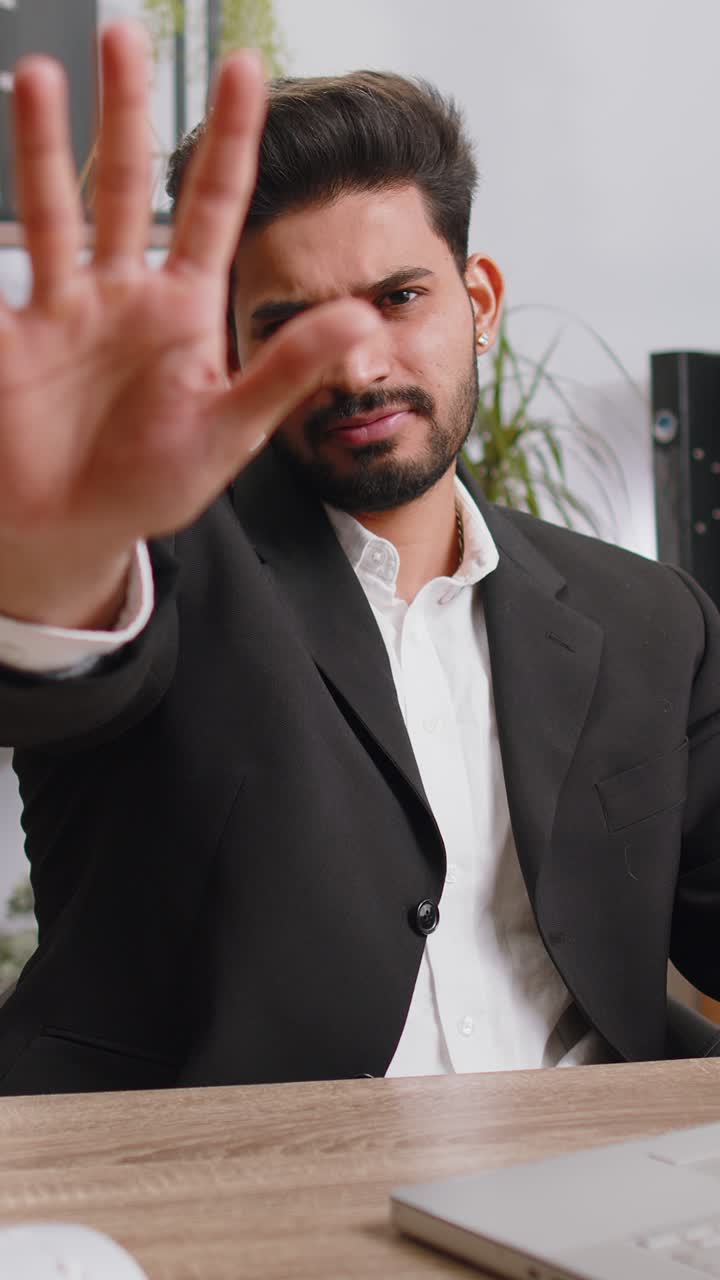 Businessman working on laptop showing stop gestuge danger rejection warning crisis prohibition