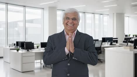 Happy-Indian-senior-manager-greeting-and-doing-Namaste