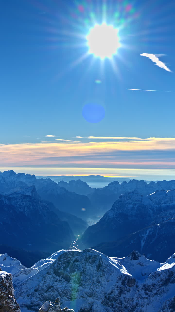 View of snow on the mountains in the Dolomites, Italy on a sunny day. Vertical