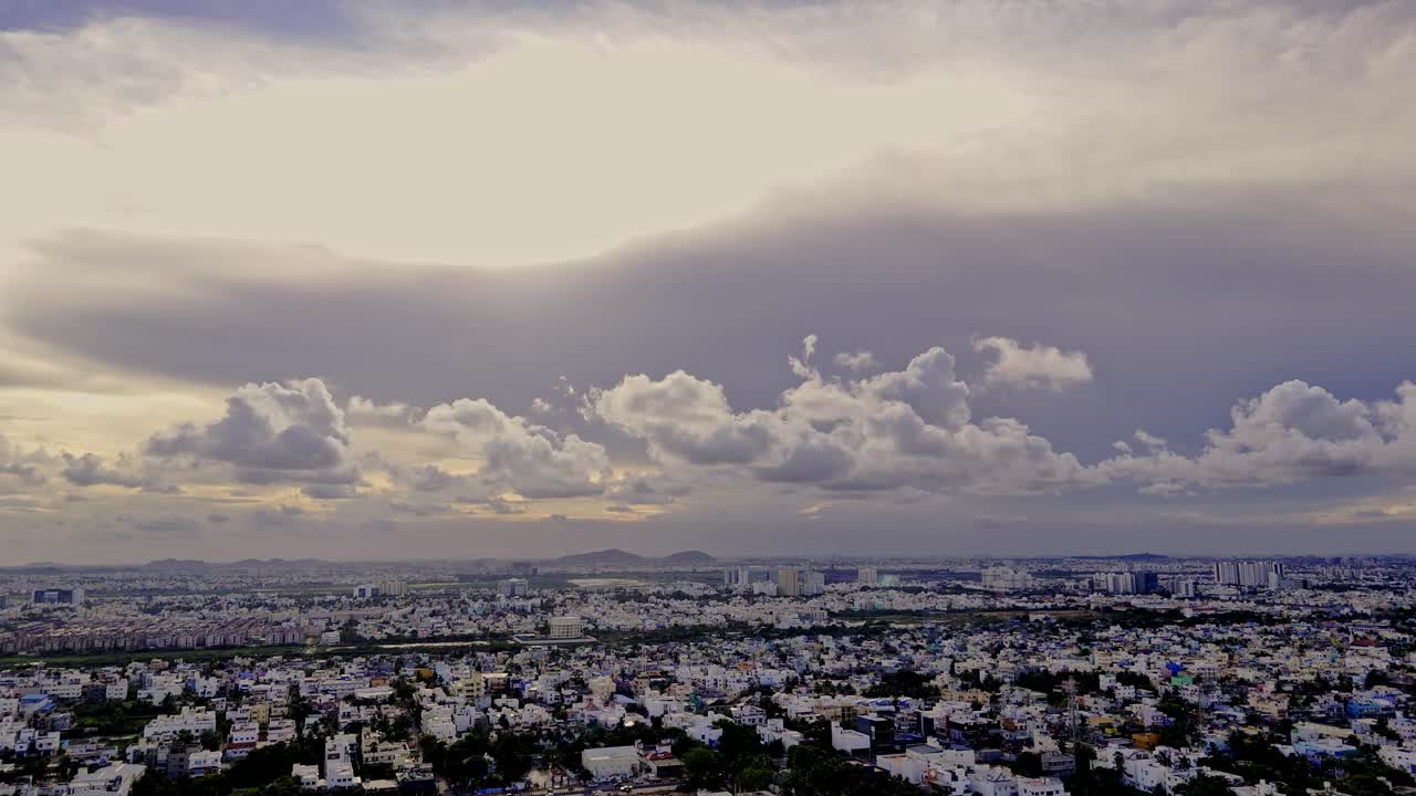 Wide angle view of densely populated suburb city with dense heavy clouds in sky prior to thunderstorm.