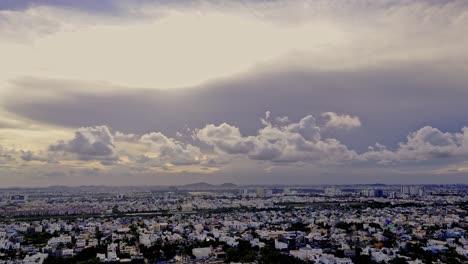 wide angle view of densely populated suburb city with dense heavy clouds in sky prior to thunderstorm.