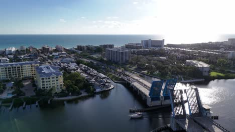 sailboat moving under the open stickney point bascule bridge connecting siesta key island with south sarasota, florida