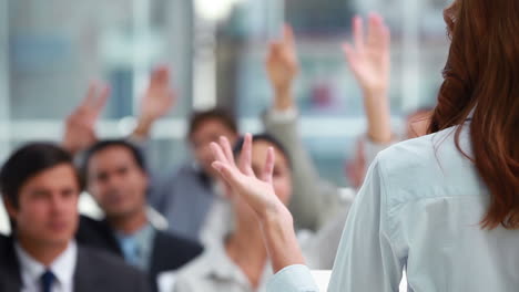 Rear-view-of-a-woman-making-a-speech