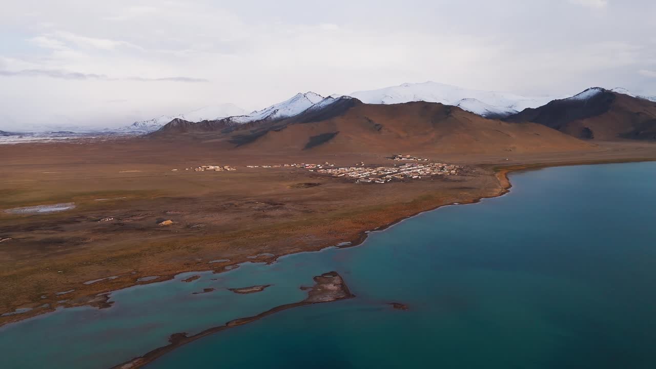 Aerial view of Karakul village on the shore of Lake Karakul, Pamir Mountains, Tajikistan travel destination adventure