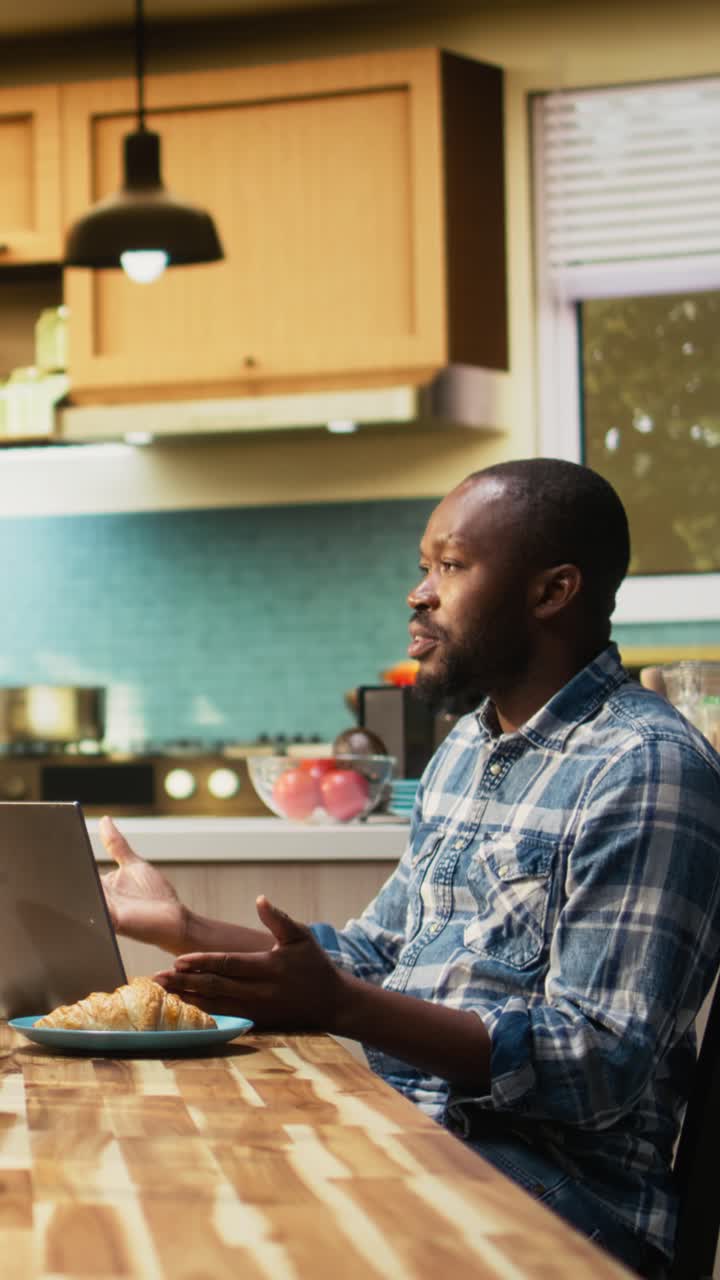 Vertical Video African american woman asking her boyfriend to stop working at breakfast