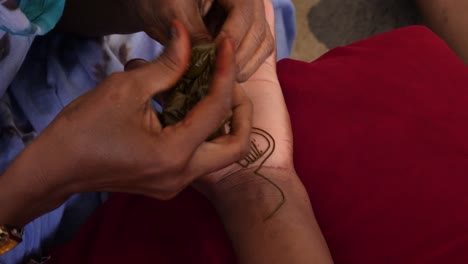 A-close-up-shot-of-a-woman-painting-a-hand-of-a-black-woman