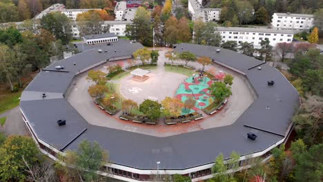 aerial view of round-shaped school building with contemporary exterior at daytime