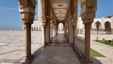 Walking-towards-Hassan-II-Mosque-islamic-worship-location,-Casablanca-Morocco