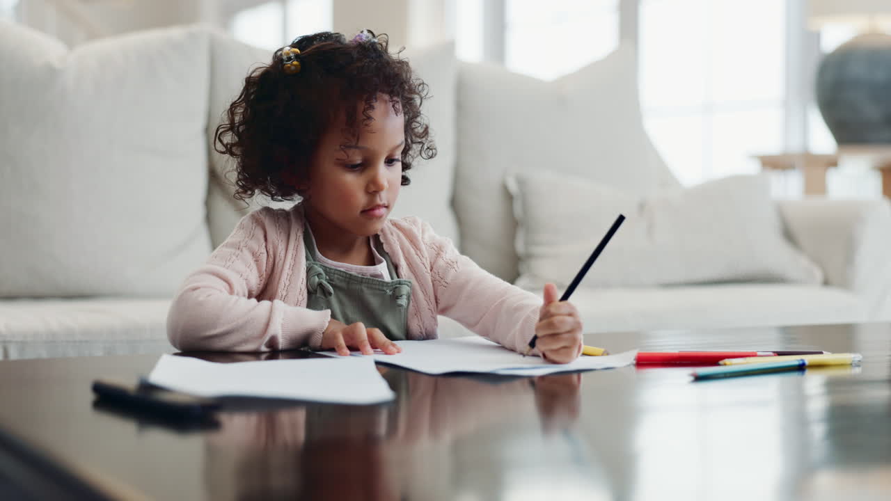 Little girl drawing on a table