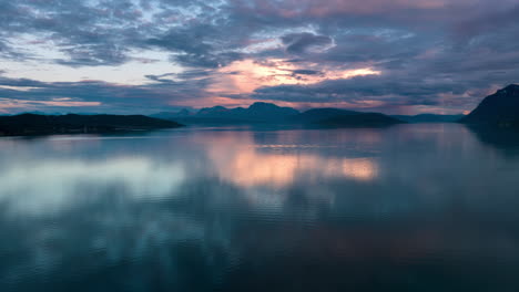 colourful sunset and reflection in norwegian fjord