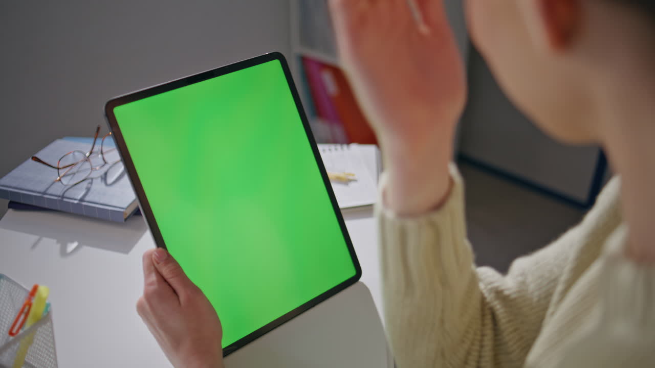 Unknown student greeting mockup tablet having video conference at school closeup