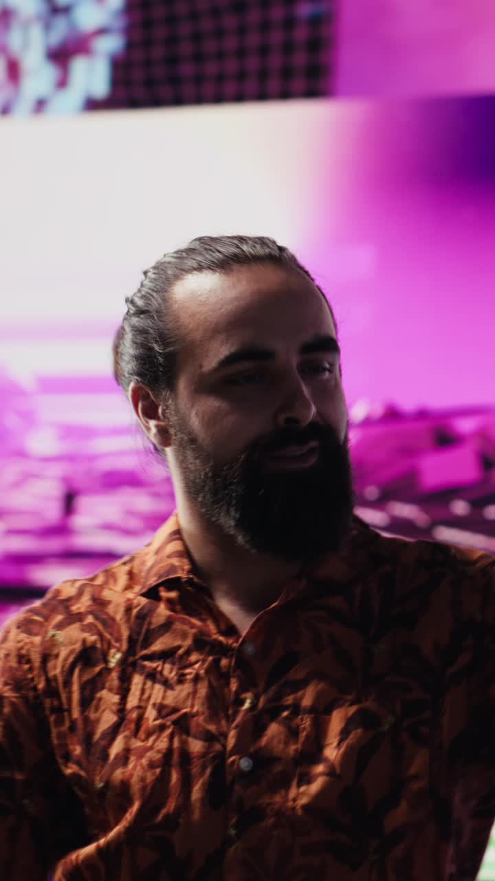 Vertical Video Cool relaxed guy using his smartphone under neon lights