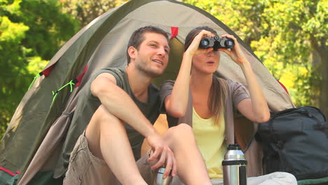 attractive couple looking through binoculars