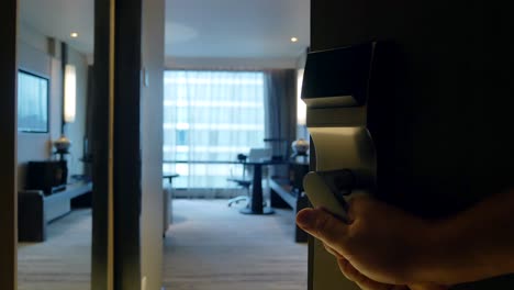 hand while open door into the hotel-bed room