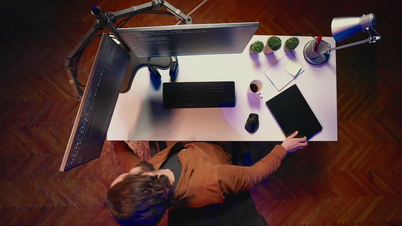 Top down view of software programmer finishing remote job shift packing backpack