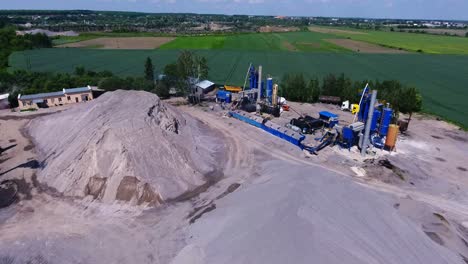 metal structures of an asphalt plant. the territory of the enterprise with building material. aerial view from above