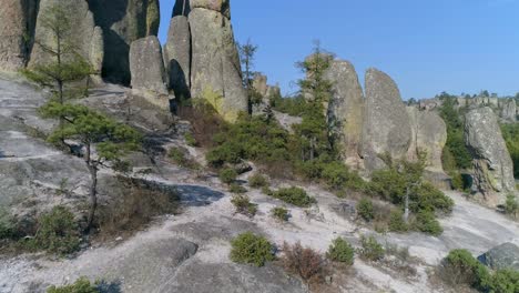 Aerial-low-flying-through-shot-of-huge-rock-formations-in-El-Valle-de-loss-Monies,-Copper-Canyon-Region,-Chihuahua