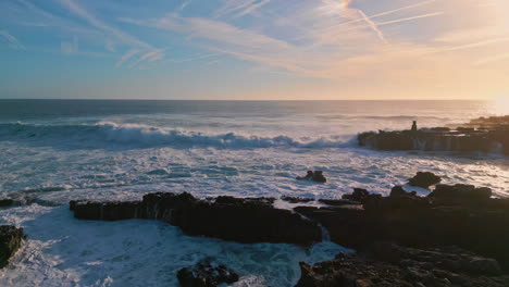 stormy sea waves splashing rough seashore rocks. aerial foamy ocean shore stones