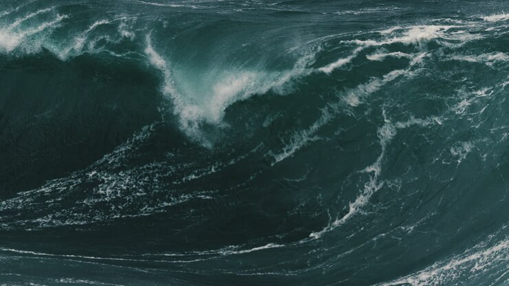 Large foamy wave barrelling onto a shallow reef
